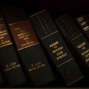 Stack of legal and literature books in a library showcasing various volumes.
